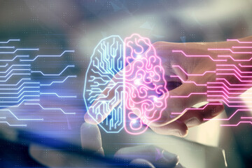 Double exposure of man's hand holding and using a digital device and brain hologram drawing. Data concept.