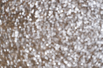 Bright shiny spotlight. Summer bokeh of sea water and wet sand on the cost. Texture, background and pattern