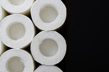 New cigarette filters with open air chambers against a dark background.  Free space for an inscription