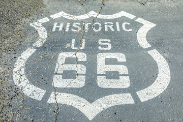 Closeup of pavement street sign on historic route 66 in Barstow, Mojave desert. Mother Road or Sixty Six background, United States of America.