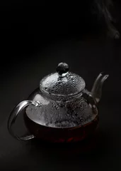 Foto op Aluminium Misted glass teapot with steam on black background © Ekaterina