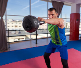 Man doing shoulder workout in the gym