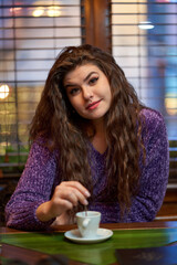 Young woman having cofee in a restaurant