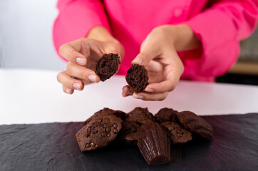 Madeleine with chocolate, fresh. Fresh bakery. pastry chef girl demonstrates dessert