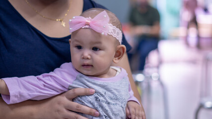 Asian Baby Girl Being Held by her Mother