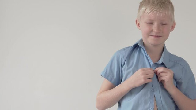 Beautiful boy blond buttons on the school shirt, close-up.