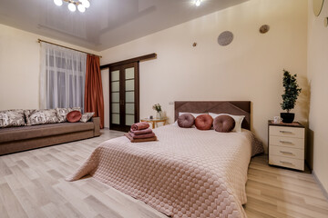 Fototapeta na wymiar Interior of modern luxure bedroom in studio apartments in light pink color style