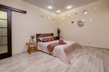 Interior of modern luxure bedroom in studio apartments in light pink color style