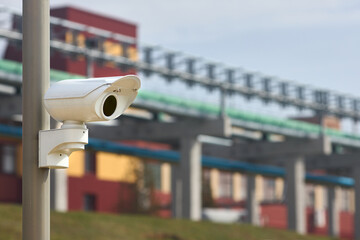 Security system of modern petrochemical plant chemical factory surveillance system CCTV camera operating to prevent theft accidents explosions catastrophes and industrial espionage with copyspace.