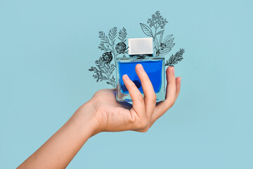 Female hand with bottle of perfume on color background