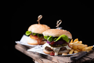 Homemade hamburger or burger with french fries on wooden table