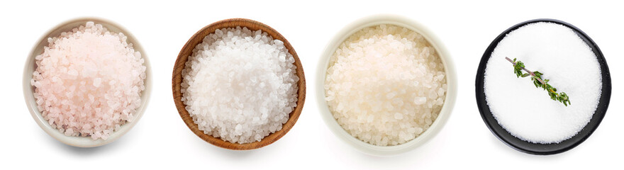 Fototapeta na wymiar Bowls of different salt on white background