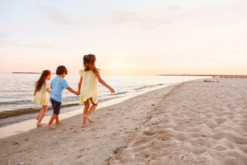 Little children having fun on sea beach