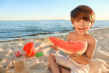 Little boy eating watermelon on sea beach - Powered by Adobe