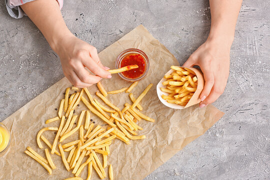 Woman Eating Tasty French Fries With Tomato Sauce, Top View