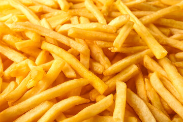 Heap of tasty french fries as background