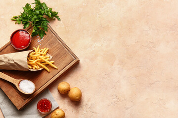 Fototapeta na wymiar Tasty french fries with tomato sauce on color background