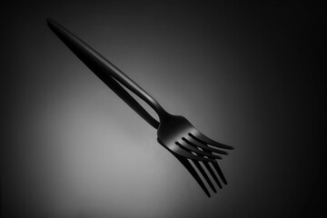 Stylish fork on dark background