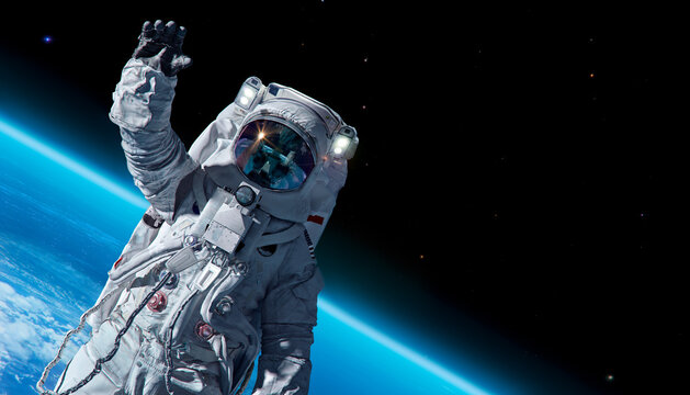 12 April 1969, International day of human space flight, Cosmonautics Day concept: ISS astronaut in spacesuit against background of the Earth planet. Astronaut in outer space, 3D science illustration