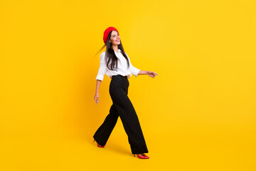 Fototapeta na wymiar Full body profile side photo of nice happy lady walk empty space wear red beret isolated on yellow color background
