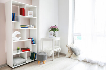 Fototapeta na wymiar Modern interior with shelf unit and books in room