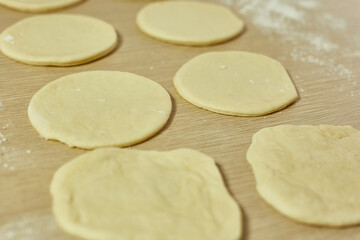 Fototapeta na wymiar housewife makes sweet dough buns, selective focus
