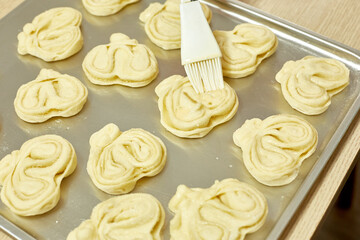 housewife makes sweet dough buns, selective focus