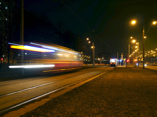 night tram motion blur light trails passing by