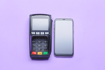 Payment terminal with mobile phone on color background - obrazy, fototapety, plakaty