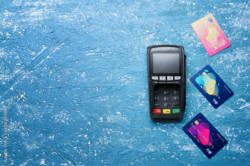 Wall mural payment terminal with credit cards on color background