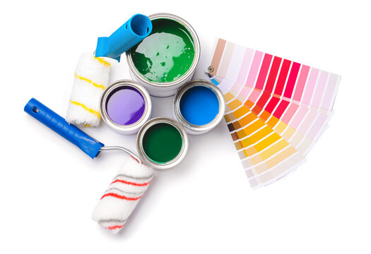 Cans of paints, rollers and palette samples on white background
