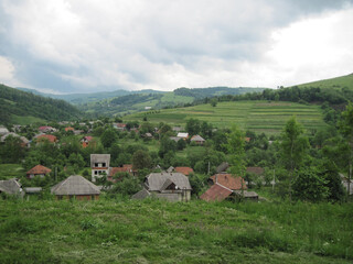 Village in the mountains. Scenic landscape on a cloudy day.