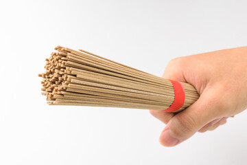 Buckwheat noodles on a white background