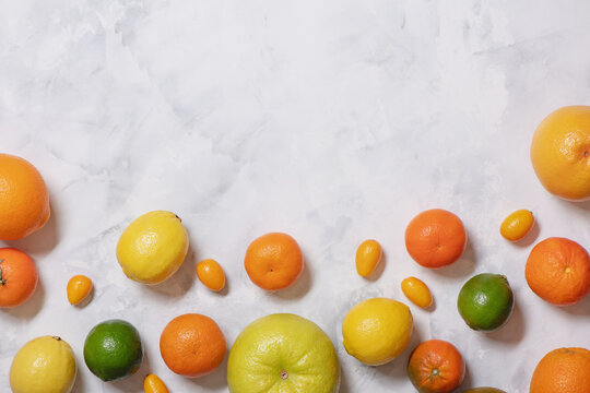 Fresh citrus fruits on marble background. © Olena Bloshchynska