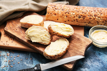 Slices of fresh bread with butter on color background, closeup