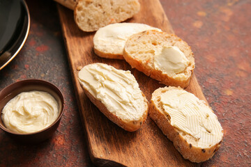 Slices of fresh bread with butter on grunge background, closeup