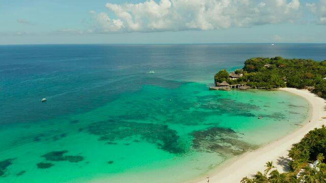 Tropical white sand beach, hotels near the blue lagoon and corall reef. aerial view, Boracay, Philippines. Seascape with beach on tropical island. Summer and travel vacation concept.