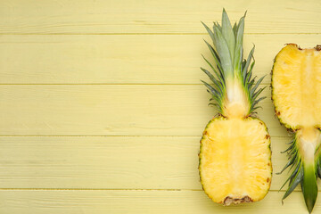 Cut fresh pineapple on color wooden background