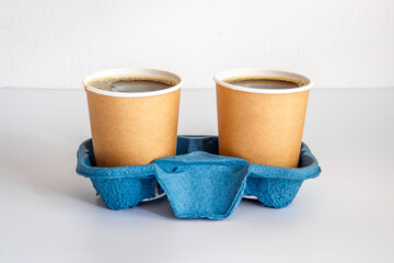 Take out coffee in paper cups on the table. Close up