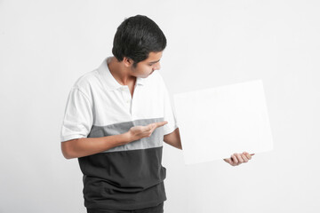 Young indian college student showing white board on white background