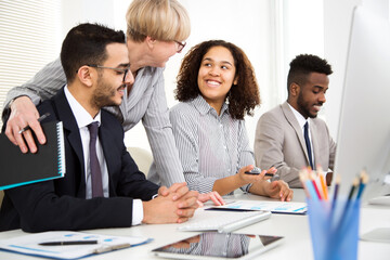 Senior business woman with young colleagues at office
