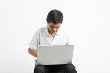 indian male college student using laptop