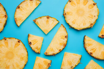 Slices of fresh pineapple on color background