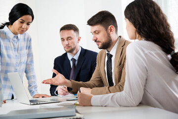 Businessman explains to colleagues a new project in the office