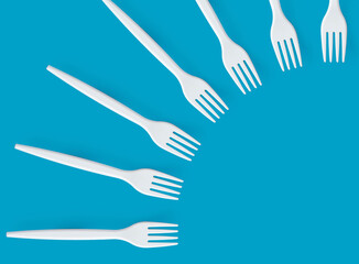 Pattern of white forks on blue background. Creative and modern concept with copy space.