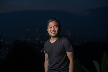 young asian man, lifestyle portrait during night.