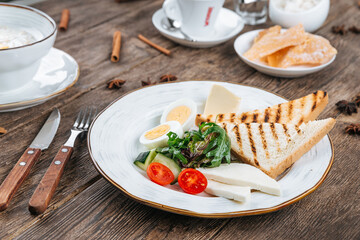 Table served with breakfast of fried eggs and toasts