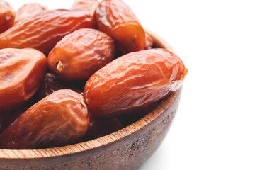 Bowl with sweet dried dates on white background
