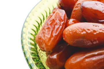 Bowl with sweet dried dates on white background