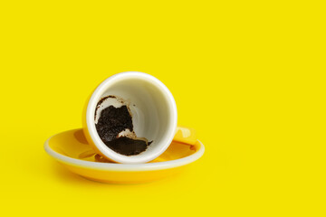 Cup with spent coffee grounds for fortune telling on color background